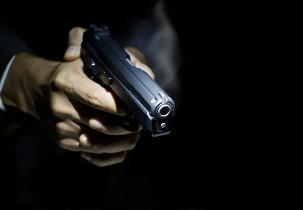 depositphotos_210297568-stock-photo-close-male-hand-holding-gun