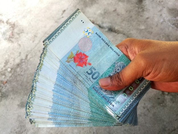 man-holds-malaysian-ringgit-bank