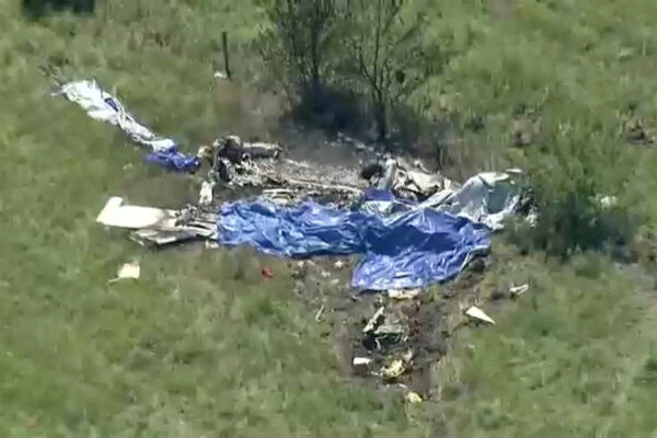 Wreckage lies in a field next to Butler Memorial Airport after a plane carrying skydivers crashed