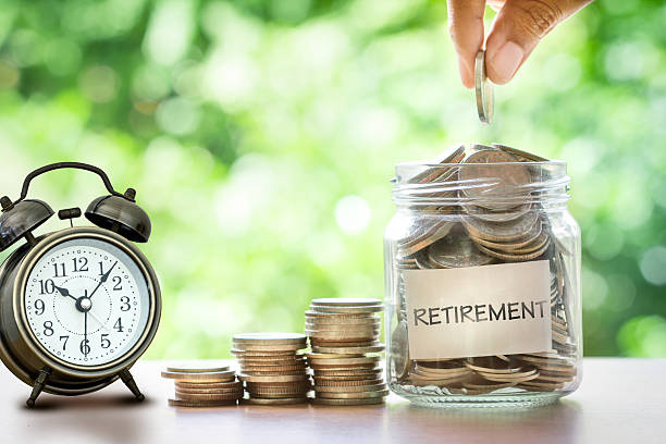 hand-putting-coins-in-glass-jar