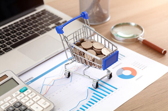 Shopping Cart with Coins on Financial Documents