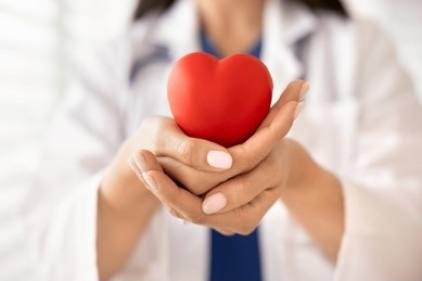 closeup-doctor-holding-red-heart