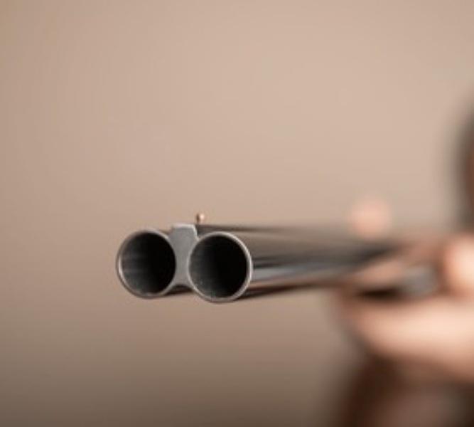 man-holding-shotgun-black-barrel
