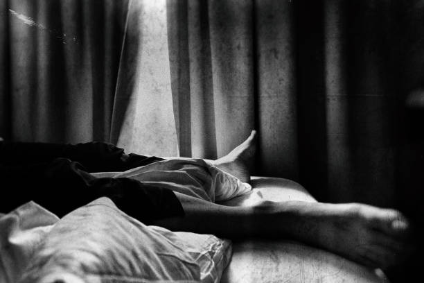 Lower body of a man lying on the bed