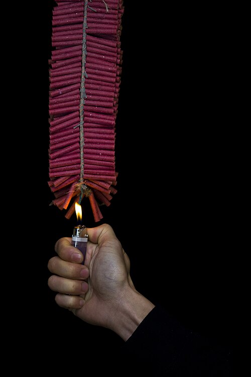 500px-Firecrackers_lit_by_hand