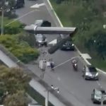 起重机倒塌横跨高架轨道 遭列车撞击火花四溅
