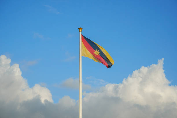 Tallest flagpole in South East Asia fly Sarawak flag with a blue sky and cloud.